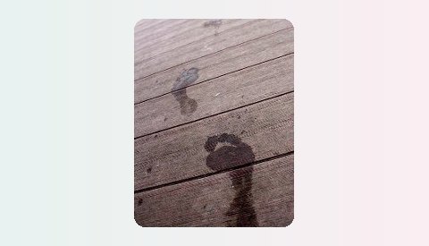 Wet footprints on a wooden deck